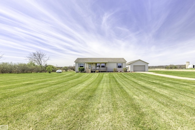 8765 Winn Rd, Brown City, MI 48416 - view of front of home featuring a detached garage, a deck, an outdoor structure, and a front lawn