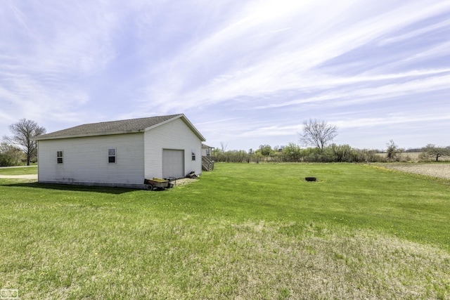 8765 Winn Rd, Brown City, MI 48416 - view of yard featuring a detached garage and an outbuilding