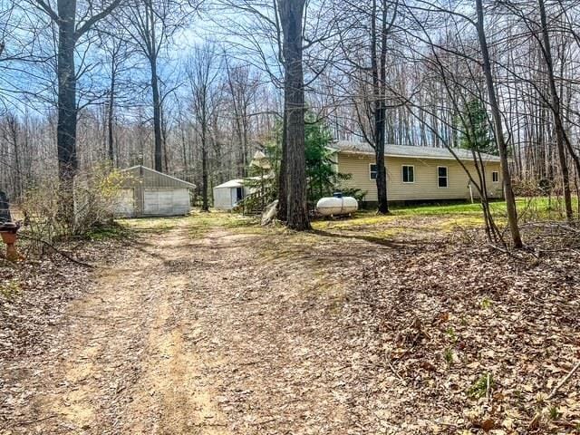 1300 Birch Rd, Harrison, MI 48625 - view of yard featuring an outbuilding and a garage
