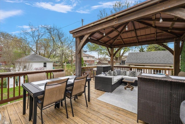 wooden deck featuring outdoor dining space, a gazebo, and outdoor lounge area