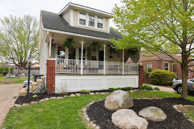 view of front of home with a porch and a shingled roof