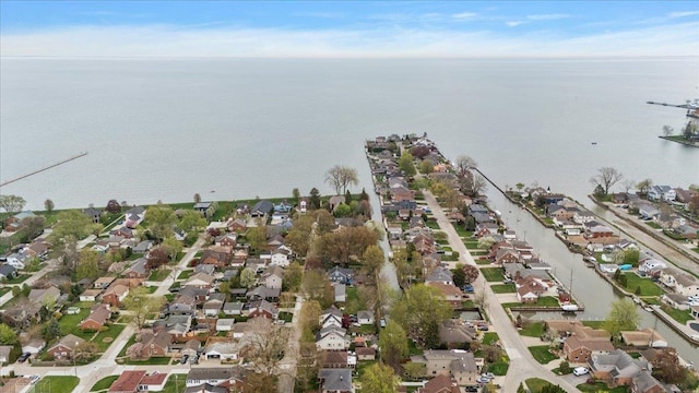 drone / aerial view featuring a residential view and a water view