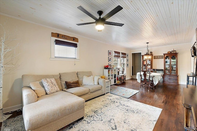 living room featuring crown molding, dark wood-style flooring, wood ceiling, and ceiling fan with notable chandelier