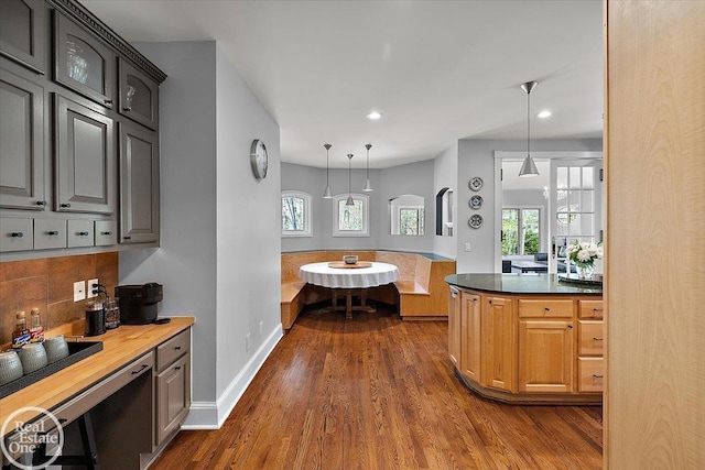 kitchen featuring dark wood-type flooring, recessed lighting, a healthy amount of sunlight, and tasteful backsplash