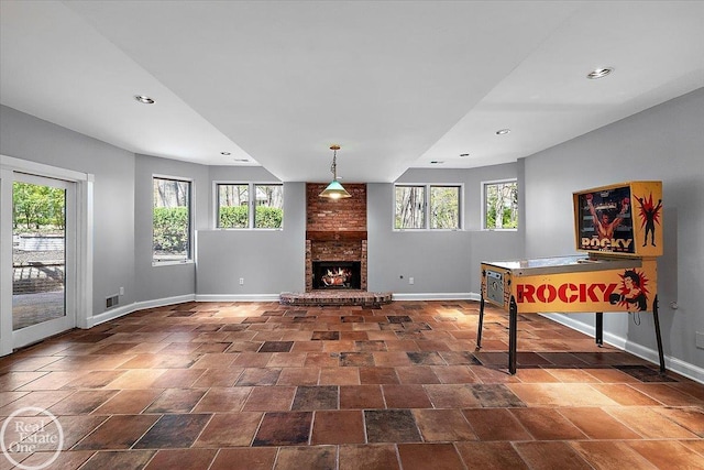 unfurnished living room featuring baseboards and plenty of natural light