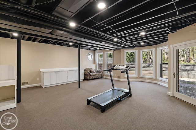 exercise area with baseboards, visible vents, and carpet