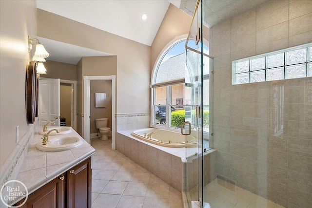 bathroom with plenty of natural light, tile patterned floors, toilet, and a shower stall