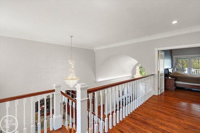 hallway featuring crown molding, an inviting chandelier, recessed lighting, an upstairs landing, and wood finished floors