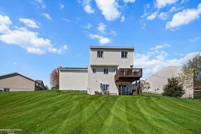 back of property with a lawn and a deck