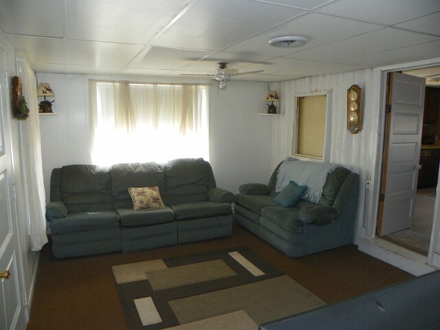 living room featuring a paneled ceiling and ceiling fan