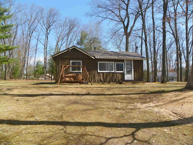 view of front of house with board and batten siding and metal roof