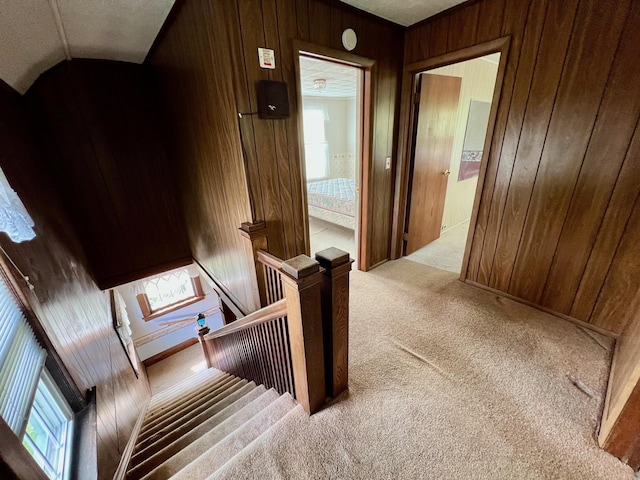 706 W Indiana St, Bay City, MI 48706 - interior space with carpet flooring, lofted ceiling, wooden walls, and an upstairs landing