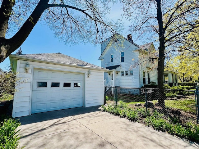 706 W Indiana St, Bay City, MI 48706 - view of side of home featuring a chimney, an outbuilding, a garage, fence, and concrete driveway