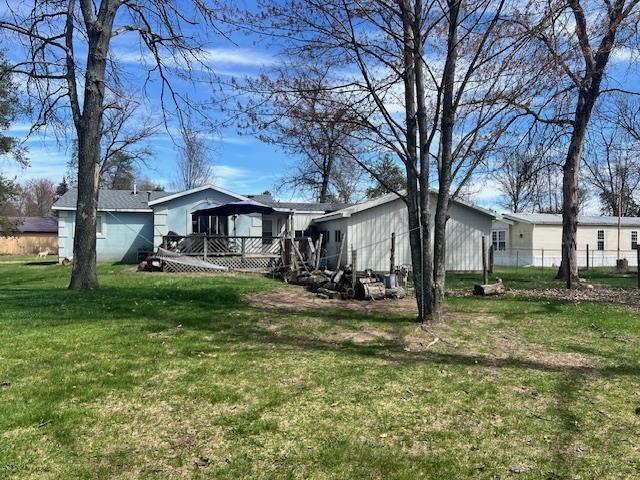view of yard with a wooden deck and fence