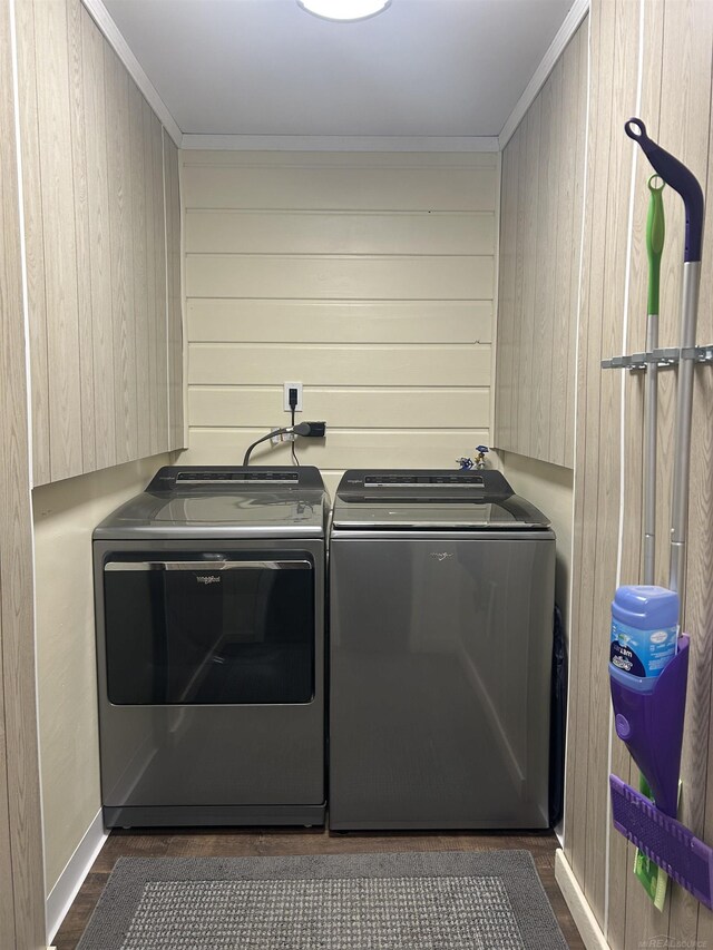 laundry area featuring ornamental molding, laundry area, wood walls, and independent washer and dryer