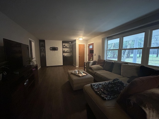 living area with baseboards and dark wood-style floors