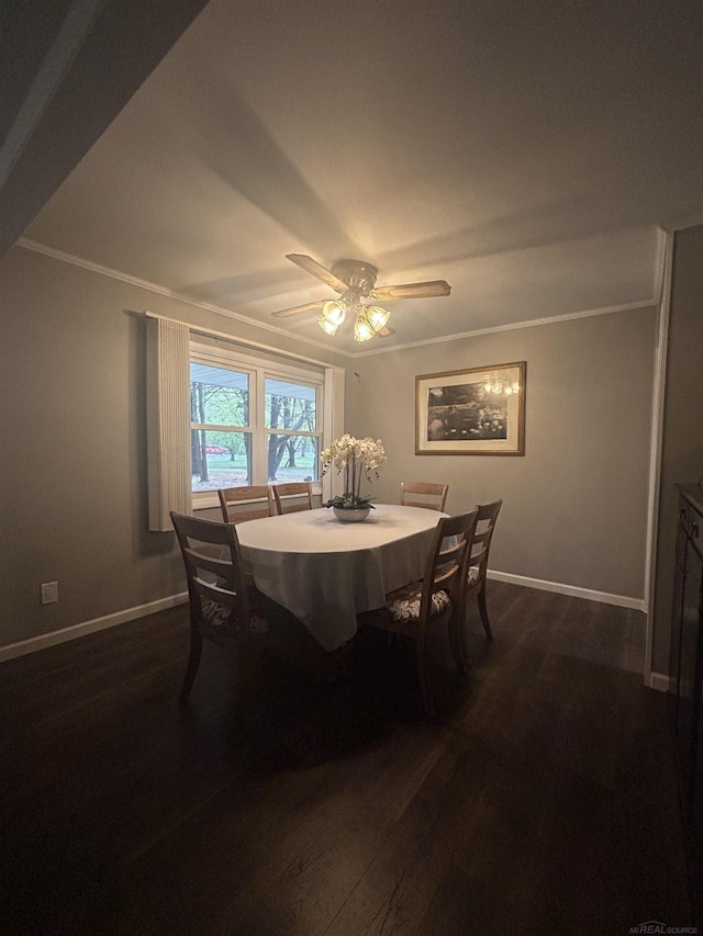 dining space featuring baseboards, ornamental molding, and dark wood-style floors
