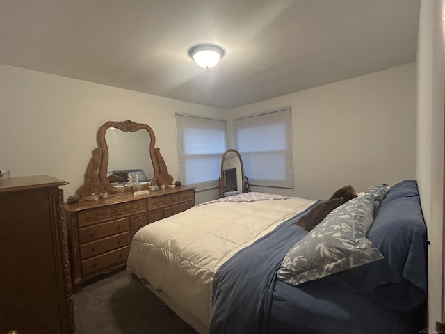 bedroom with dark colored carpet