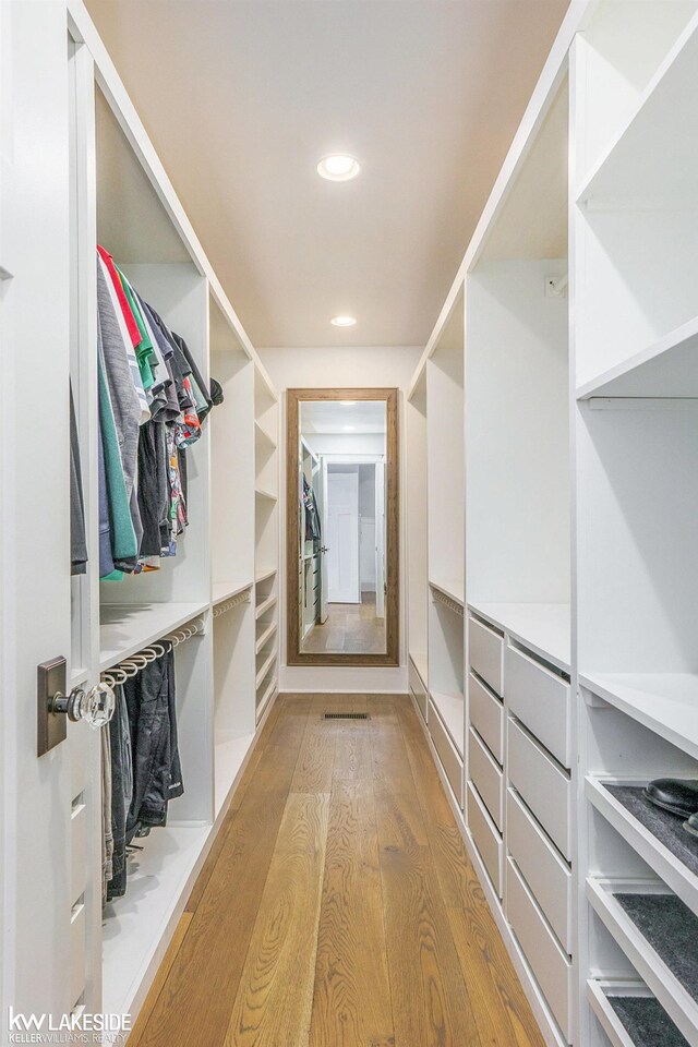 walk in closet featuring wood finished floors