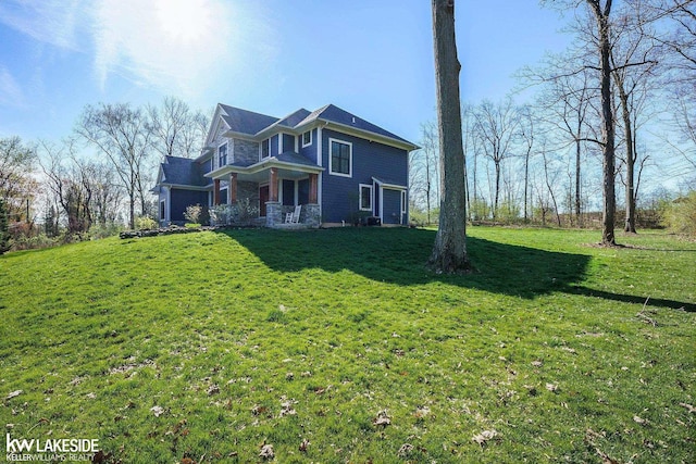exterior space featuring a yard and stone siding