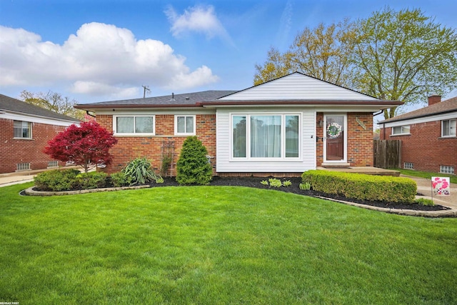 view of front facade featuring brick siding and a front lawn
