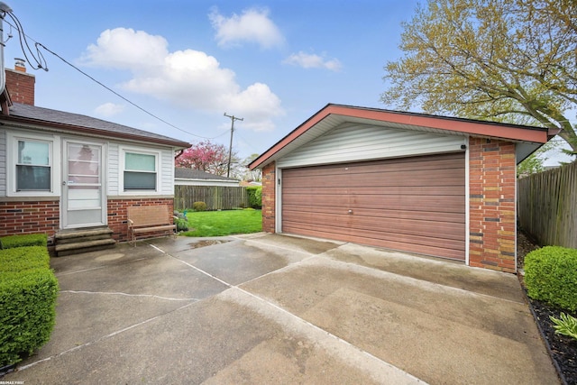 detached garage featuring fence