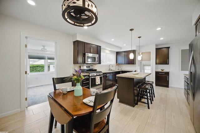 dining space with recessed lighting, baseboards, a wealth of natural light, and light wood-type flooring