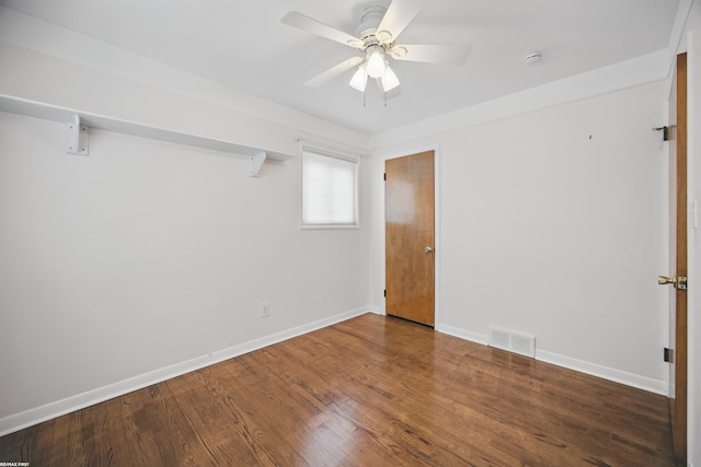 spare room featuring baseboards, a ceiling fan, wood finished floors, and visible vents