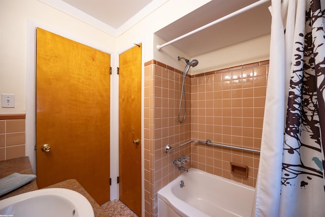 bathroom featuring a sink and shower / bath combination with curtain