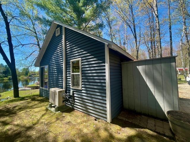1548 Pioneer Rd, Alger, MI 48610 - view of outdoor structure with a water view and central air condition unit