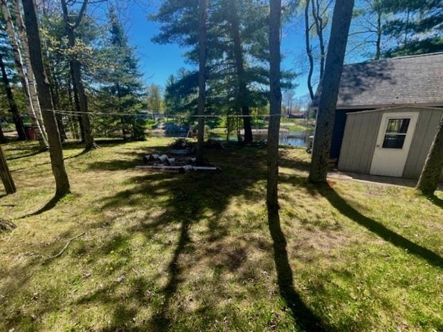 1548 Pioneer Rd, Alger, MI 48610 - view of yard featuring a storage shed and an outdoor structure