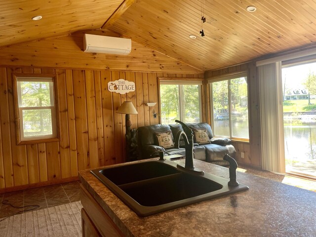 1548 Pioneer Rd, Alger, MI 48610 - interior space featuring an AC wall unit, a sink, wooden walls, and vaulted ceiling