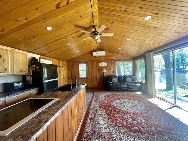 kitchen featuring lofted ceiling, wooden ceiling, a sink, and black appliances