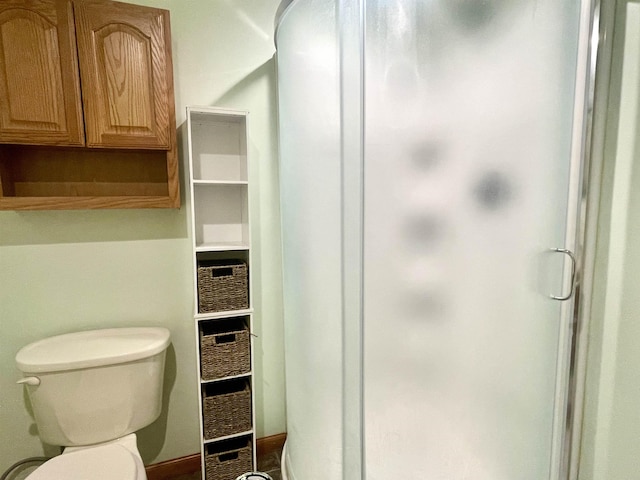 full bath featuring toilet and a shower stall