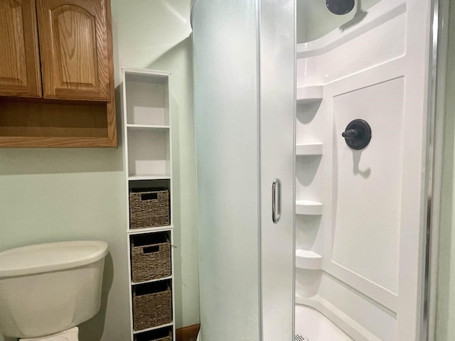bathroom with toilet and a shower stall