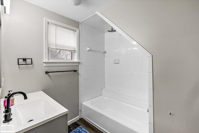 455 Garfield Rd, Fostoria, MI 48435 - bathroom with a sink, wood finished floors, and shower / washtub combination