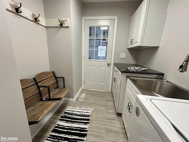 36870 Hebel Rd, Richmond Twp, MI 48062 - laundry room with cabinet space, a sink, and light wood-style flooring