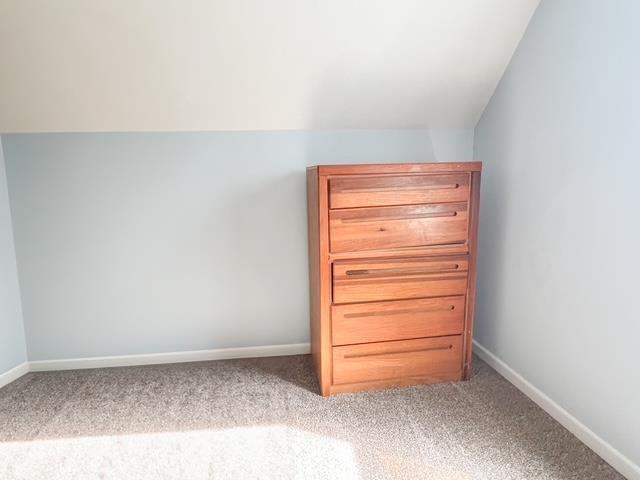 unfurnished bedroom with baseboards and carpet