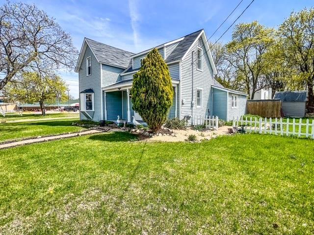 view of property exterior featuring a lawn and fence