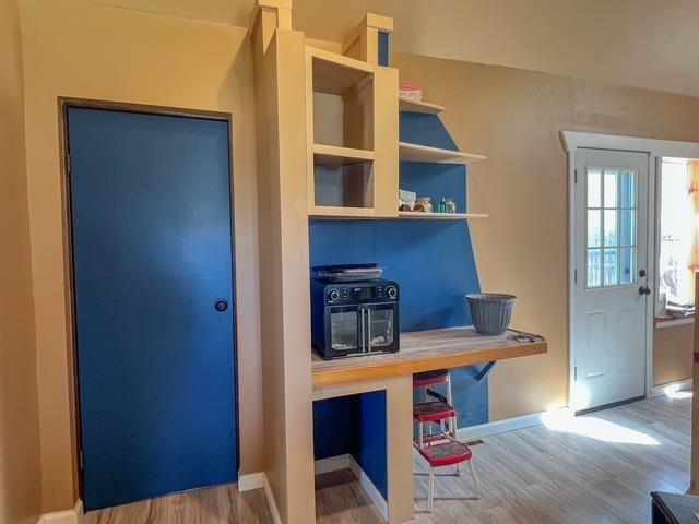 mudroom featuring baseboards and wood finished floors