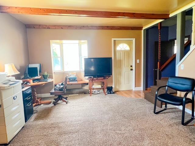 office featuring carpet floors, beamed ceiling, and baseboards