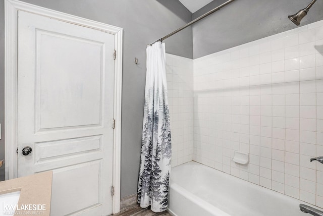 full bathroom with shower / bathtub combination with curtain and wood finished floors