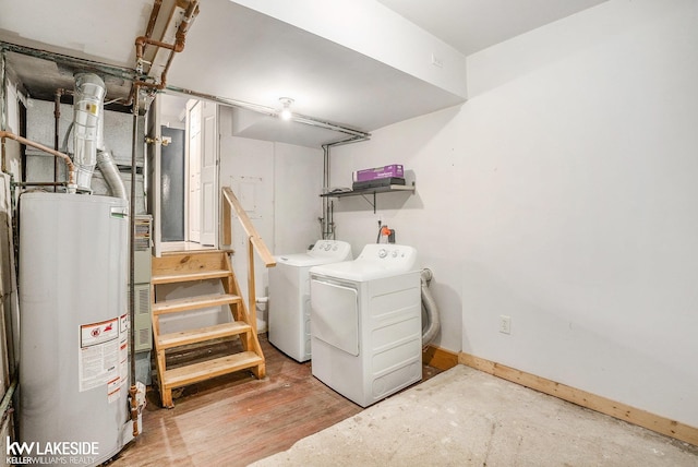 laundry room featuring washing machine and clothes dryer, baseboards, and water heater