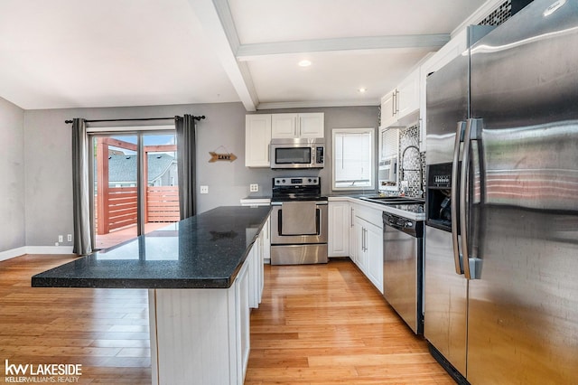 kitchen featuring white cabinets, stainless steel appliances, a sink, and light wood finished floors