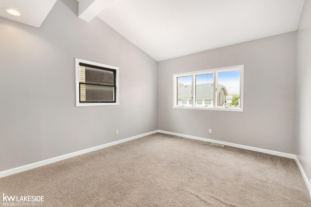 carpeted empty room with baseboards, visible vents, and lofted ceiling with beams