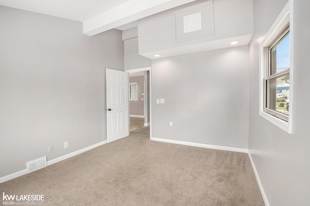 carpeted spare room with recessed lighting, baseboards, and visible vents