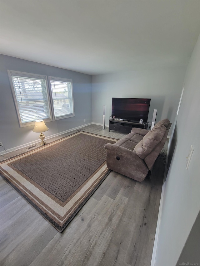 living room featuring baseboards and wood finished floors