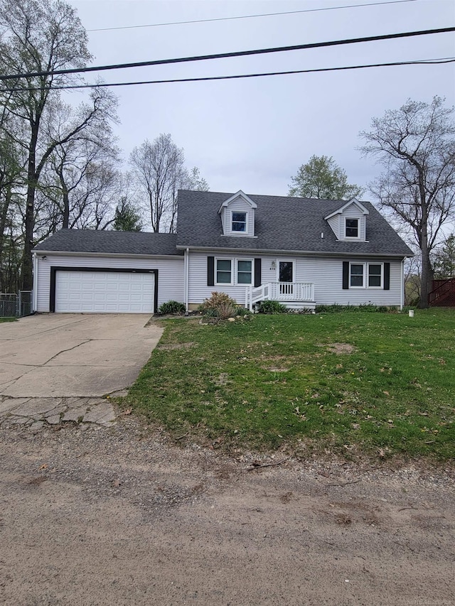 cape cod home featuring an attached garage, driveway, a shingled roof, and a front yard
