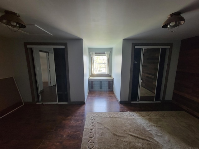 hallway featuring baseboards and wood finished floors