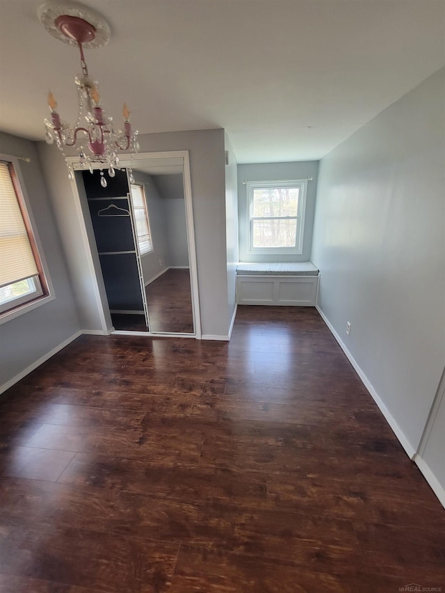 unfurnished dining area with baseboards, an inviting chandelier, and plenty of natural light